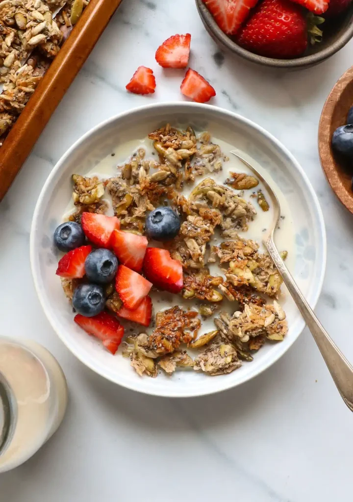 granola bowl with milk and berries